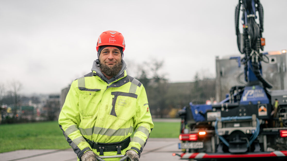 Cteam worker in PPE standing by heavy equipment, ready for consulting and construction projects. Cteam worker in PPE standing by heavy equipment, ready for consulting and construction projects.