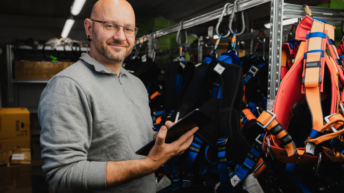 Industrial safety expert from Cteam inspecting fall protection equipment with digital tool. Industrial safety expert from Cteam inspecting fall protection equipment with digital tool.